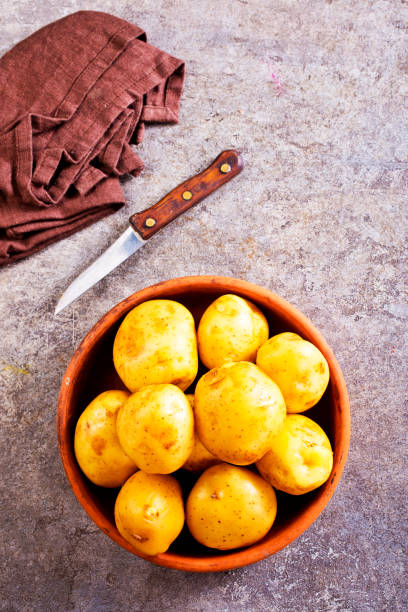 istock bowl with raw potatoes on a table 2169794671
