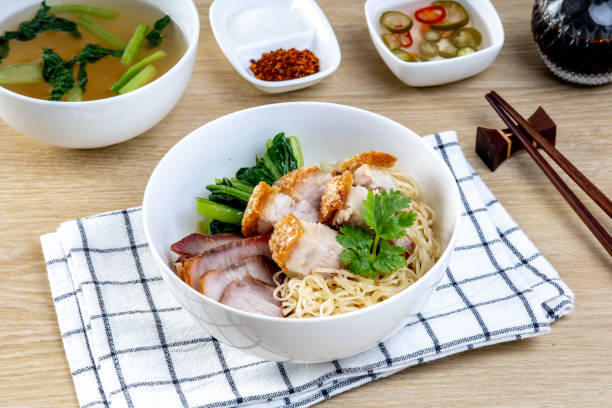 istock Red pork and crispy pork noodles on a wooden table 2169795864