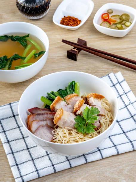 istock Red pork and crispy pork noodles on a wooden table 2169795865
