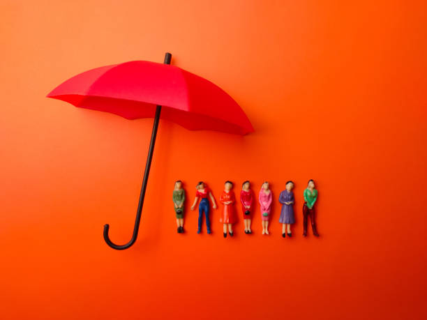 istock Miniature people women protected by red umbrella 2169800793