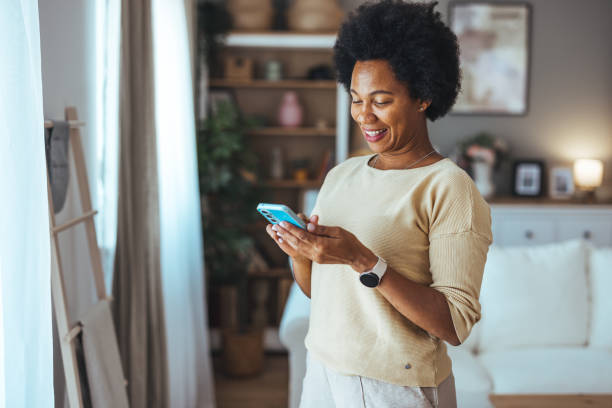 istock Young woman using the mobile phone at home. 2169802705