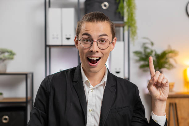 istock Happy young businessman in formal suit thinking and using laptop computer at home office desk 2169803285