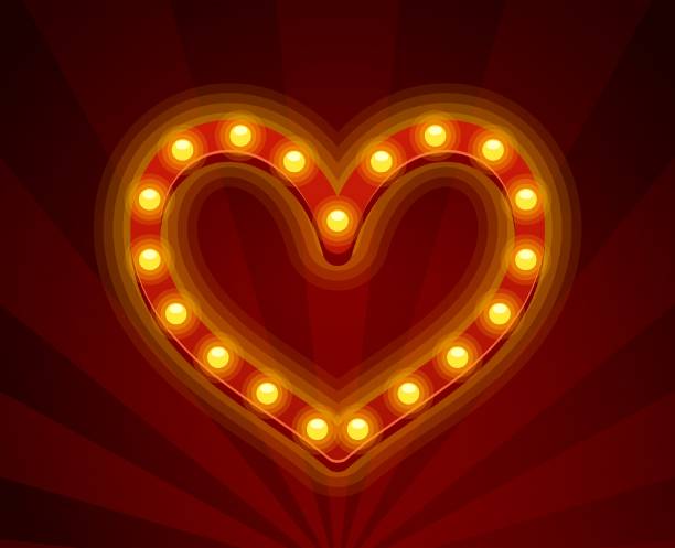 istock Radiant Heart Shape Composed Of Bright Retro Light Bulbs Illuminating Against A Radiant Red Background 2169803664