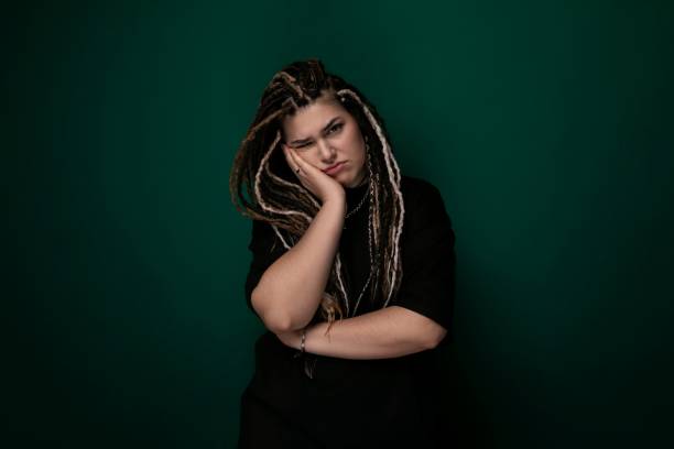 istock Woman With Dreadlocks Standing in Front of Green Wall 2169805336