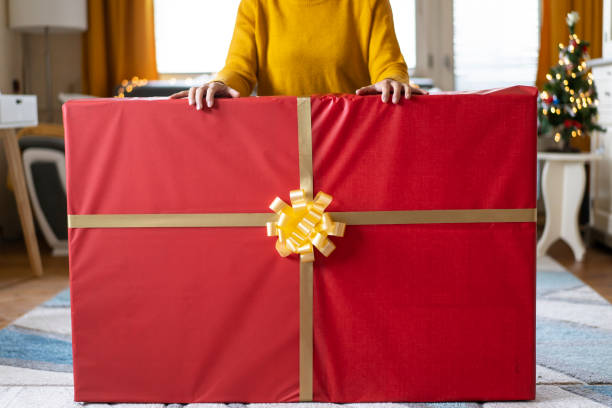 istock Holding a very large Christmas gift 2169805755