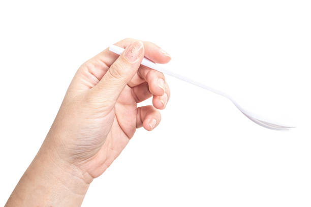 istock Female hand holding a white plastic spoon isolated on white background. 2169806204