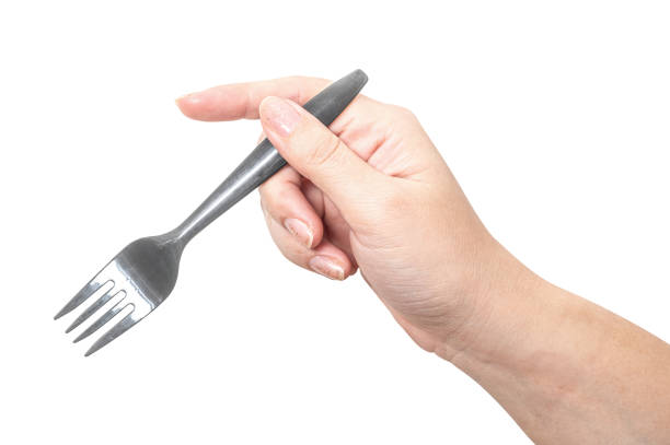 istock Female hand holding a black plastic fork isolated on white background. 2169806208