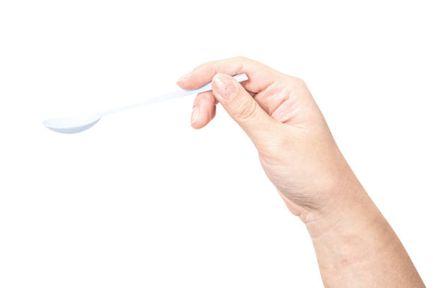 istock Female hand holding a white plastic spoon isolated on white background. 2169806218