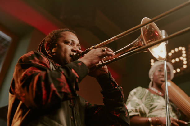istock Young Man Playing Trombone In Jazz Band 2169814563