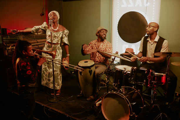 Wide shot of modern jazz band consisting of four members performing on stage in local bar