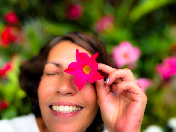 Woman happy with Beautiful flowers in the garden