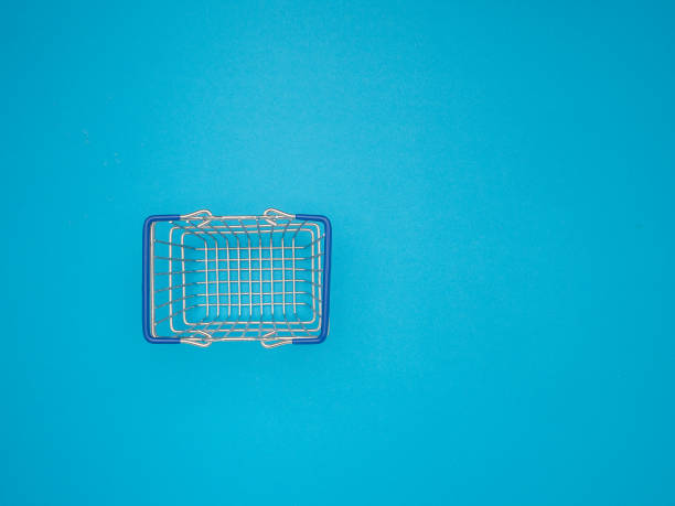 A small empty supermarket grocery shopping basket mockup is isolated on a blue background. Top view.