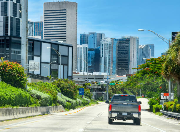 Traffic lights for traffic regulation high above street in Miami, Florida.
