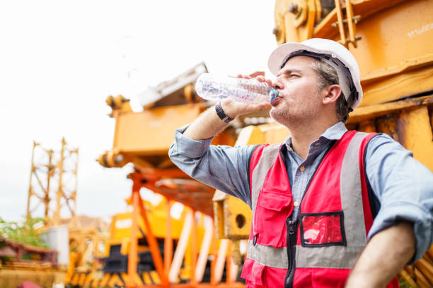 istock Thirsty and tired worker setting on the floor. 2169820023