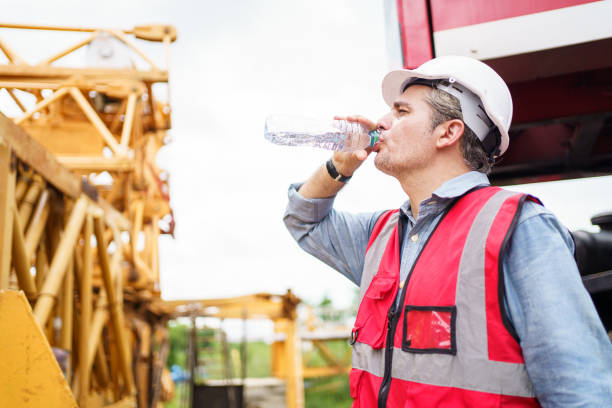 istock Thirsty and tired worker setting on the floor. 2169820025