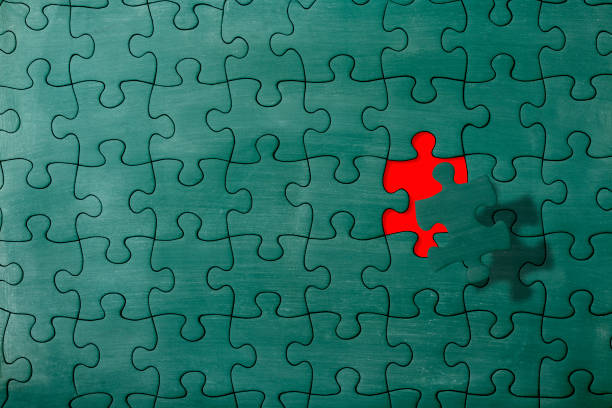 Close-up of Chalkboard jigsaw puzzle in mid-air against jigsaw puzzle made from chalkboard.\nFinal Piece of the Puzzle