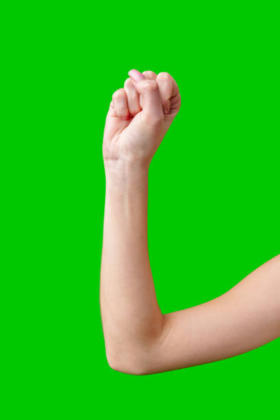 istock Woman's Arm With Fist Raised Against Green Screen 2169824609