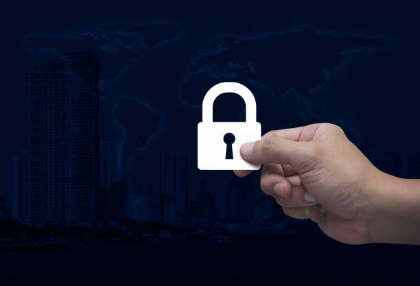 Hand holding padlock flat icon in fingers over world map, modern city tower and skyscraper, Technology internet security and safety online concept, Elements of this image furnished by NASA