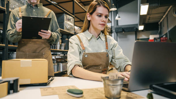istock Two small business team members checking inventory and  packing new orders online for customer eco friendly brown paper wrapped with environmental Sustainability friendly  before shipping to customers ,zero waster and plastic free  quality control 2169825113
