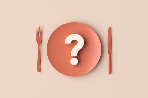 Question mark lying on a plate with knife and fork on the side