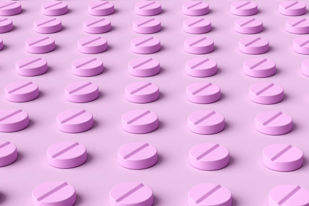 istock Rows of round pink pills forming a geometric pattern. 2169825670