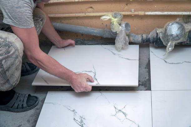 istock A male builder lays floor ceramic tiles 2169826139