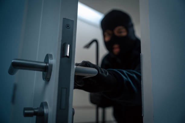 istock Thief in uniform black jacket various action housebreak. The Robber terrorism criminal escapes with balaclava and crowbar entering a house for stealing Housebreak at night 2169828756