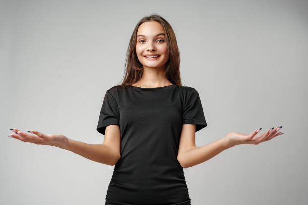 istock Young Woman in a Beige Blazer Gesturing With Open Palms 2169829396