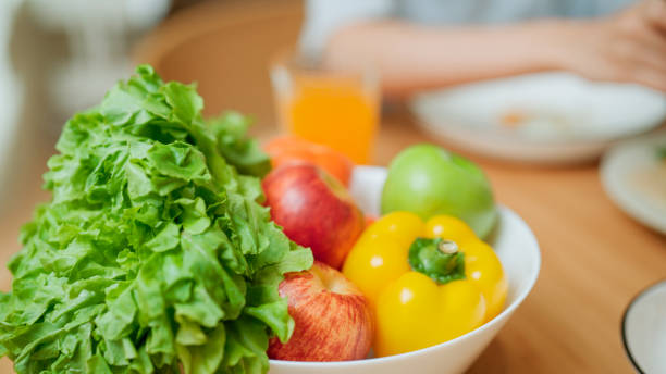 A close-up view of a homemade salad being served in a plate as a dinner at home on a dining table.