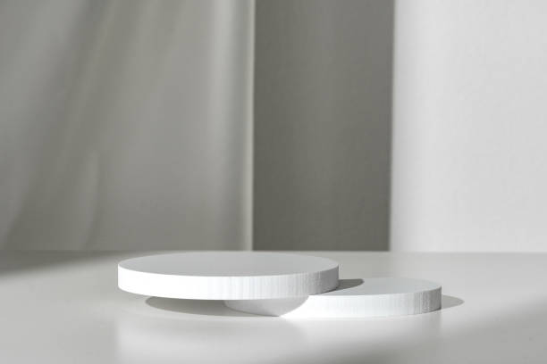 istock Modern Minimalist White Sculpture Displayed on Soft Draped Fabric in Natural Light 2169829527