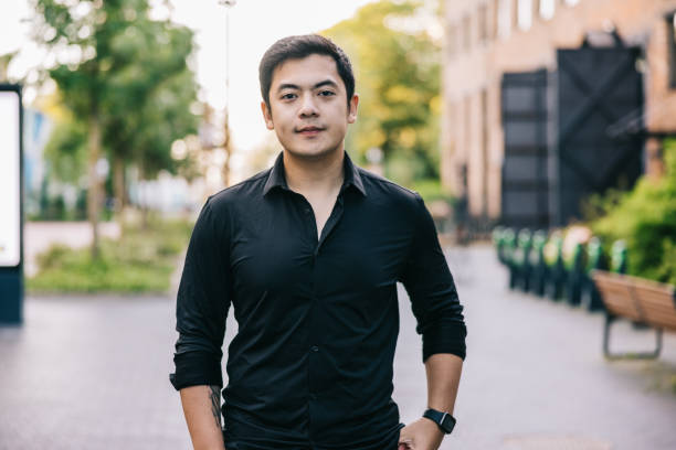 istock Young Asian businessman stands with a confident smile 2169832079