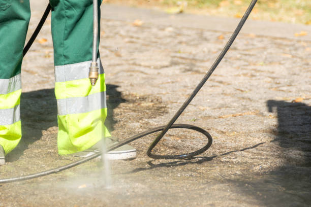 istock selective focus, a public cleaning worker cleaning the street with high pressurized water 2169833366