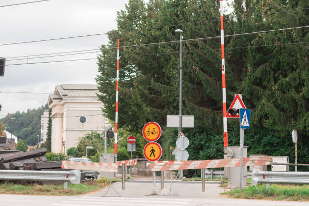 istock Renovating level grade crossing. Barriers over pedestrian train crossing, with visible trafficsigns to prevent people going over 2169833556