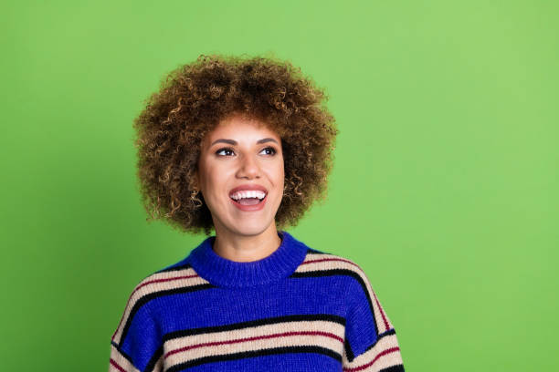 istock Portrait of positive girl with perming coiffure dressed knit pullover look at offer empty space isolated on green color background 2169835125