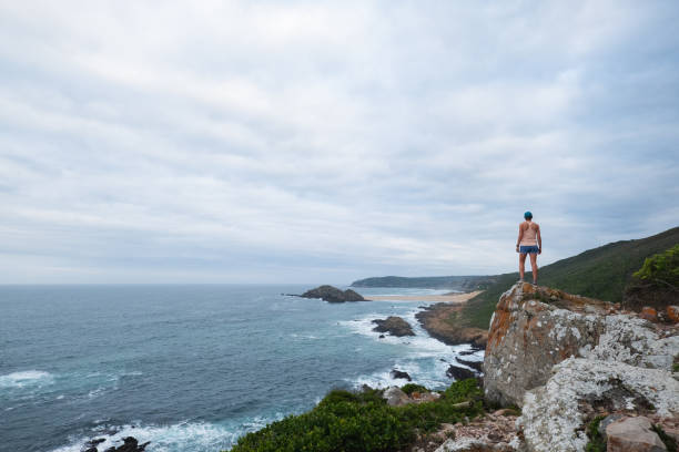 istock Active woman looking at view over the beautiful coastline 2169835190
