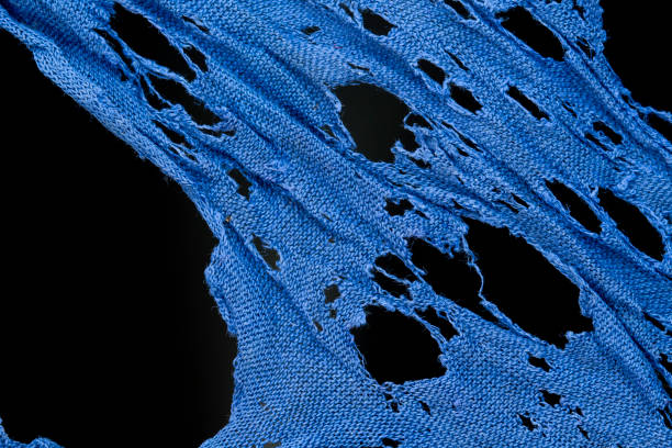 blue clothing material background damaged and holed