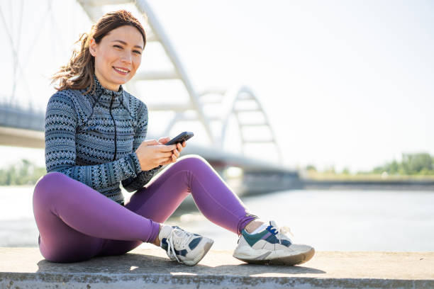 istock Sporty woman using smart phone outdoors. 2169836713