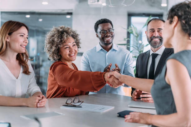 istock Businesspeople shaking hands across the table. 2169837282