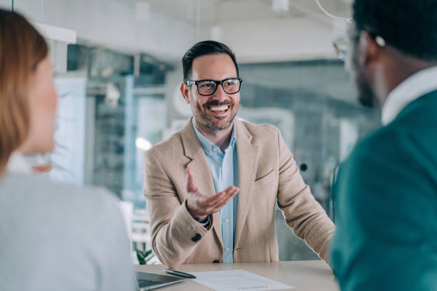 istock Group of business persons talking in the office. 2169837302