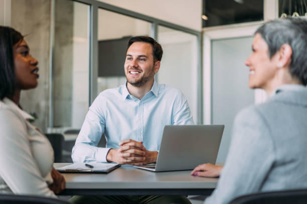 istock Group of business persons talking in the office. 2169837779