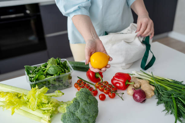 istock In a contemporary kitchen, a woman is unloading fresh groceries using ecofriendly bags 2169837920