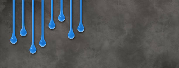 istock Blue ink drops on dark concrete wall. Horizontal banner 2169838997