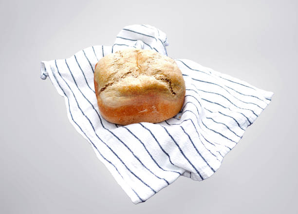 fresh bread lies on a white tablecloth