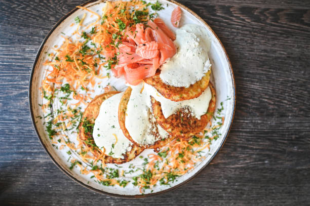 istock Potato pancakes with smoked salmon top view. 2169840589