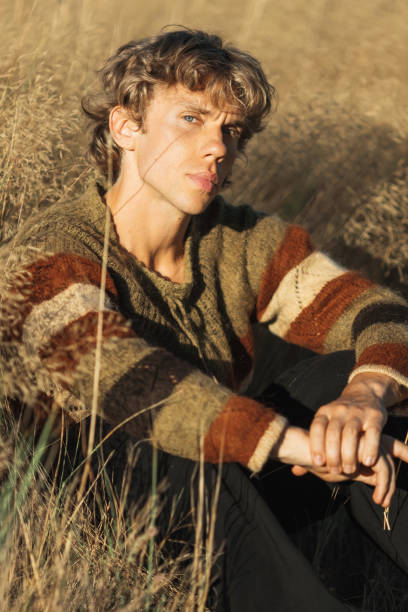 istock Blonde man in sweater. Autumn nature 2169841620