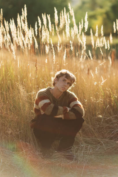 Blonde man in sweater. Autumn nature