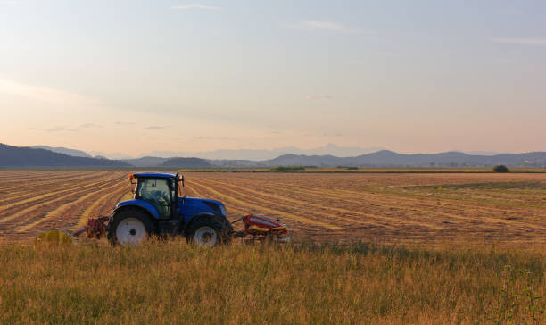 Tractor at the Edge of a Field at Sunset