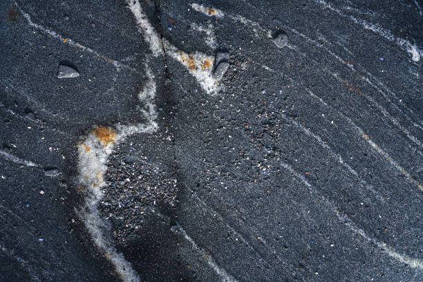 Dark rough natural rock texture background, directly above
