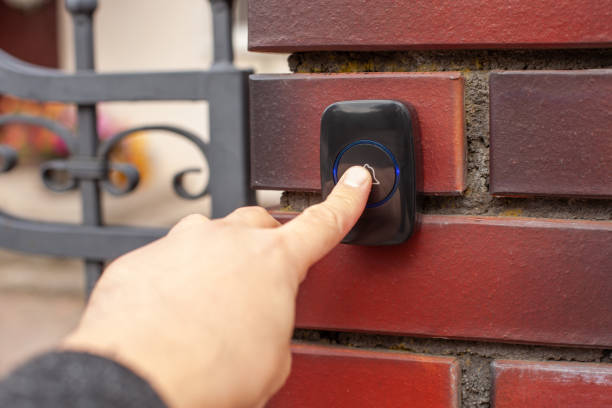istock Hand Pressing Doorbell on Red Brick Wall 2169849485