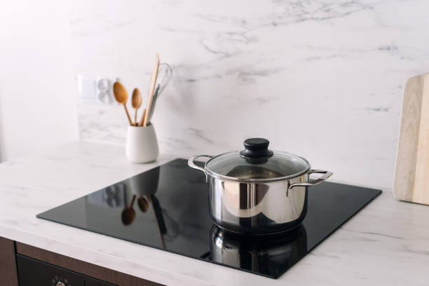 istock Stainless steel pan with lid at glass ceramic hob on kitchen 2169849771